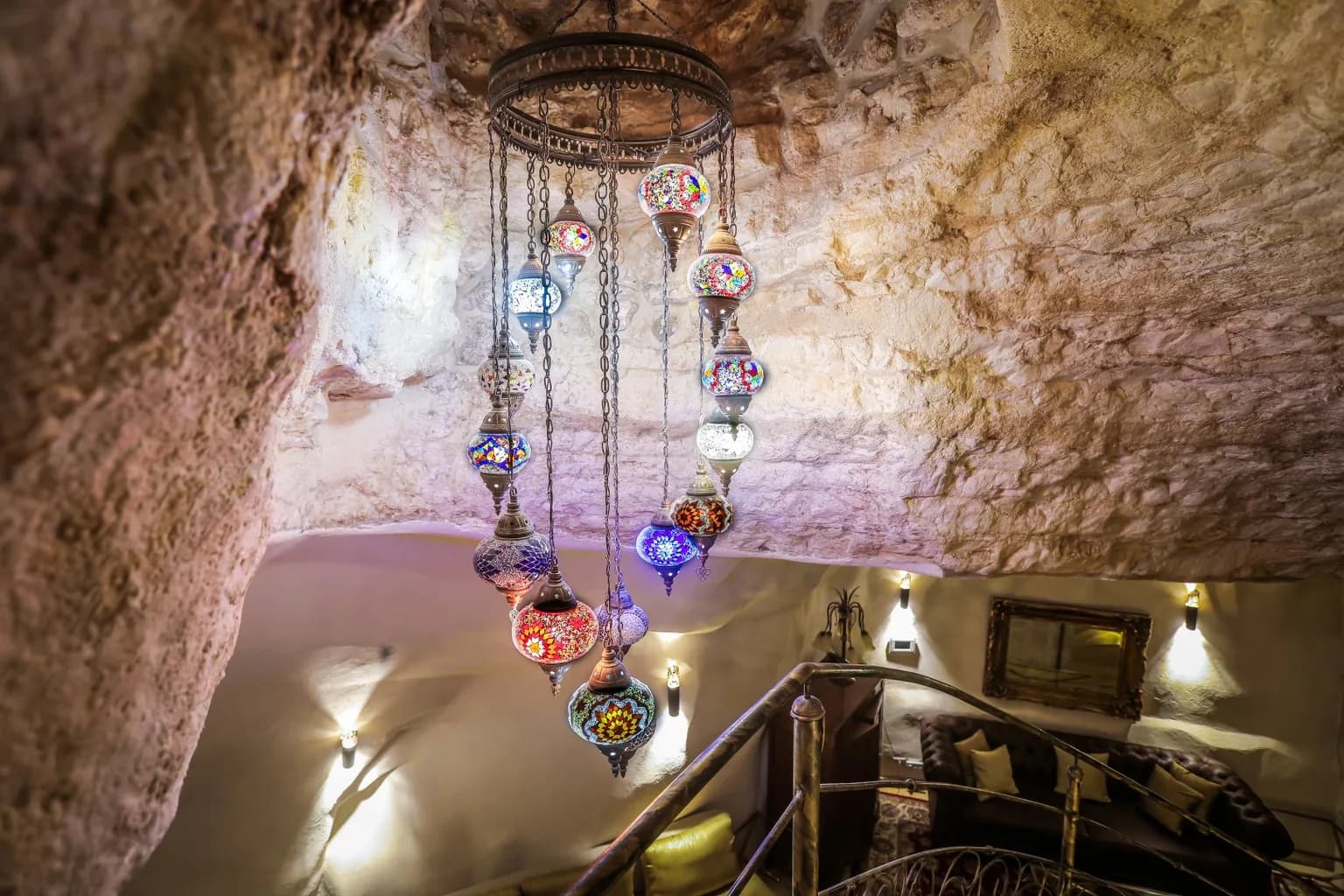 Historic stone ceiling with colorful oriental lantern chandelier.